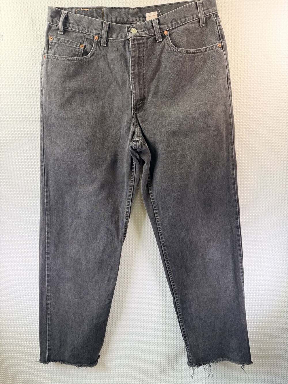 Vintage Levi's 550 Relaxed Fit Tapered Leg Jeans in Faded Black with Raw Hem